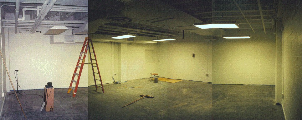 photograph of an empty room with cement floor, ceiling, and walls