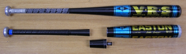 photograph of two bats, one cut open to show the location of the V.R.S. absorber